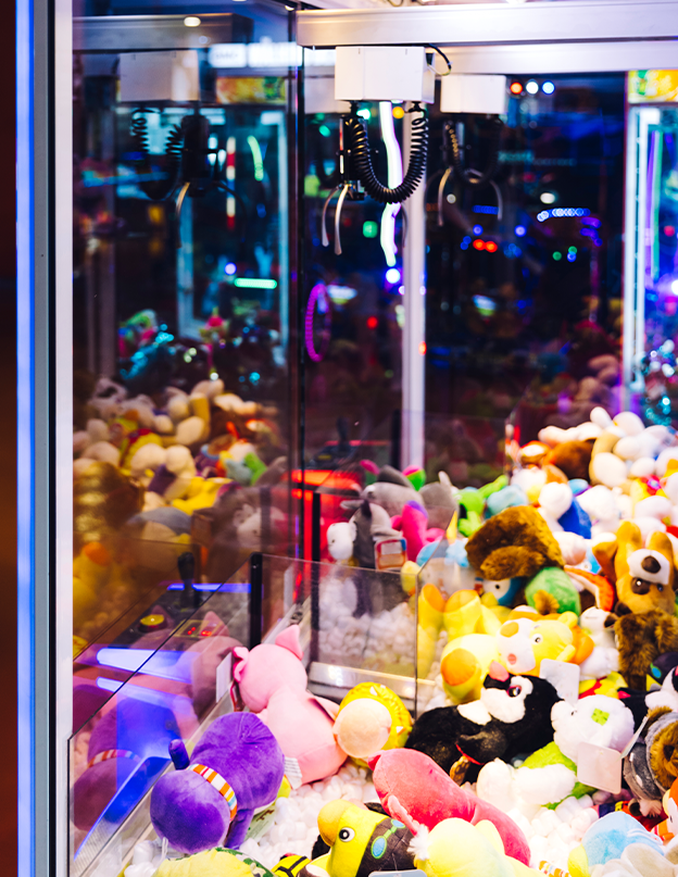 Interactive arcade claw machine with electronic controls